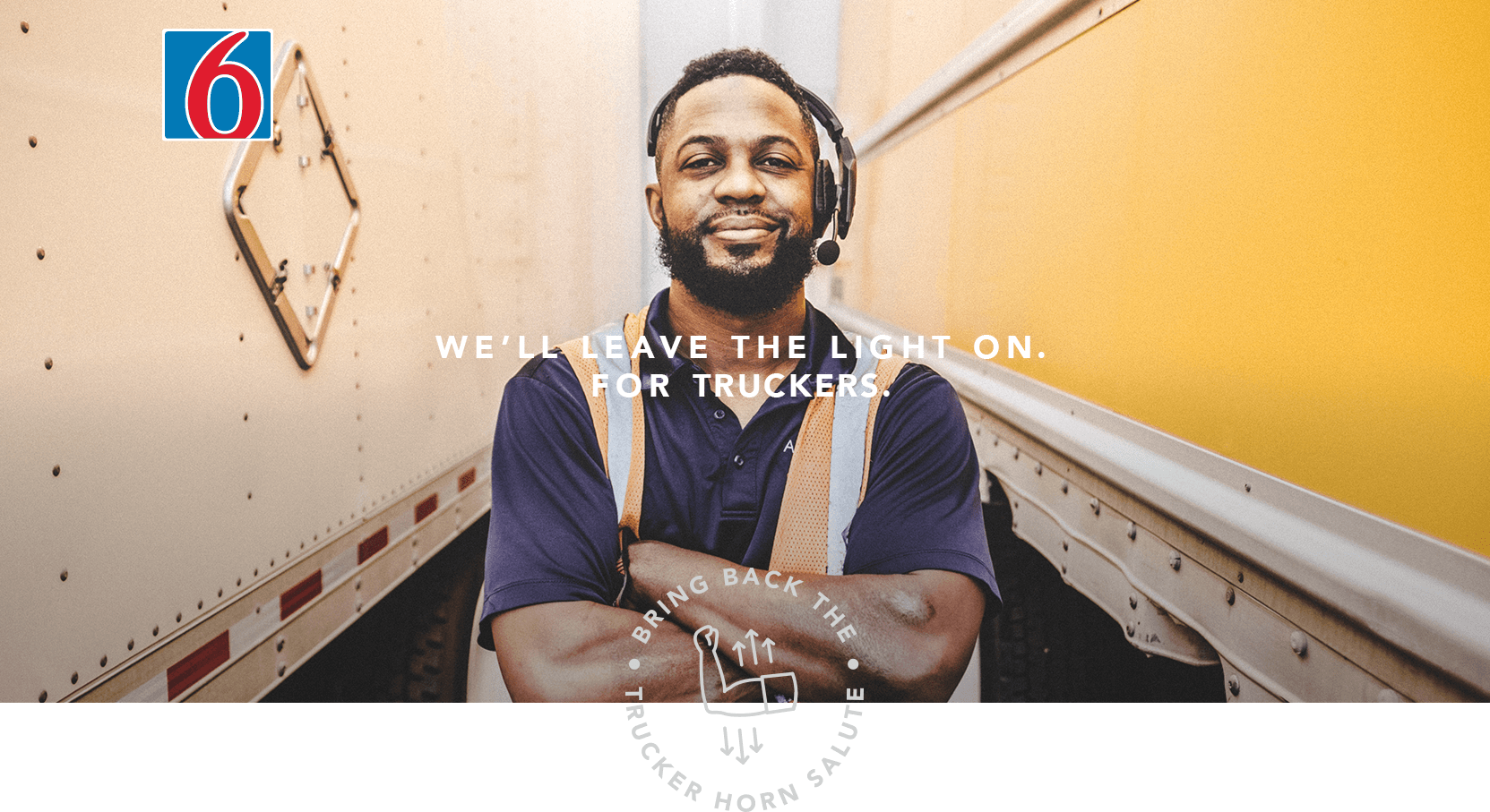 A picture of a man stabding with his arms crossed in front of two semi trailers. The copy reads 'We'll leave the light on. For truckers.'